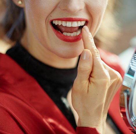 Woman pointing to her tooth